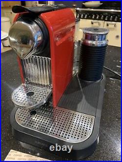 Red Nespresso coffee machine with milk frother