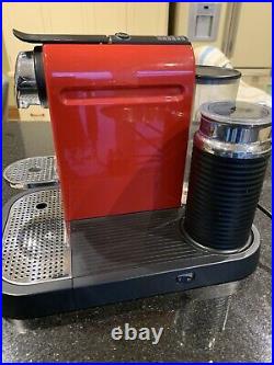 Red Nespresso coffee machine with milk frother