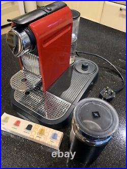 Red Nespresso coffee machine with milk frother