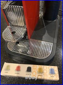 Red Nespresso coffee machine with milk frother